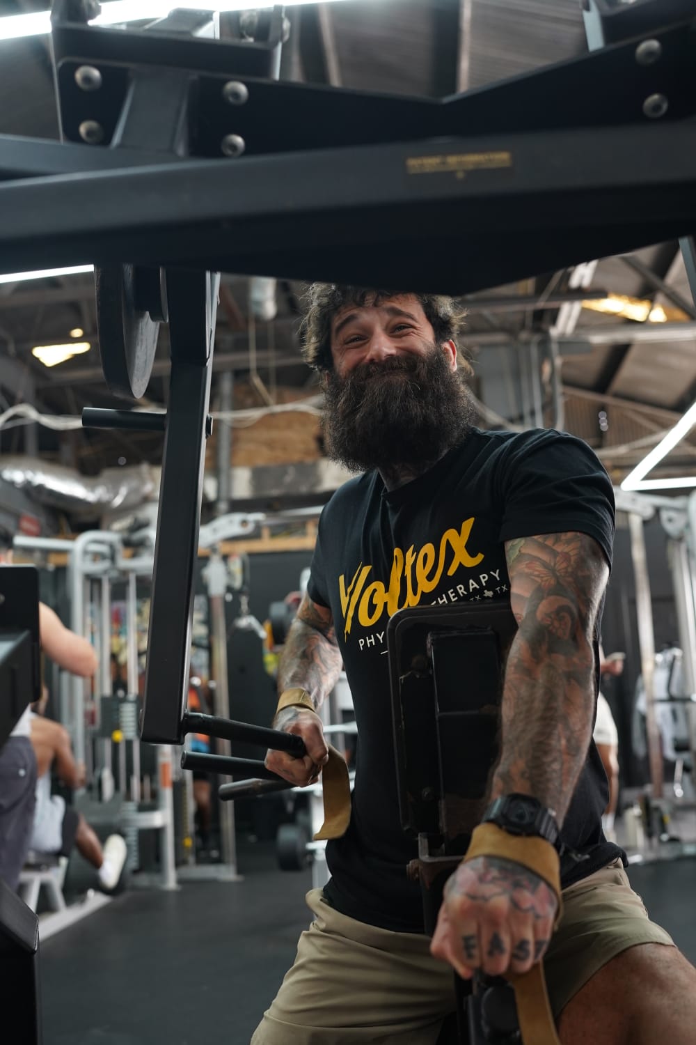 Joe Brooker smiling while training his back in the gym