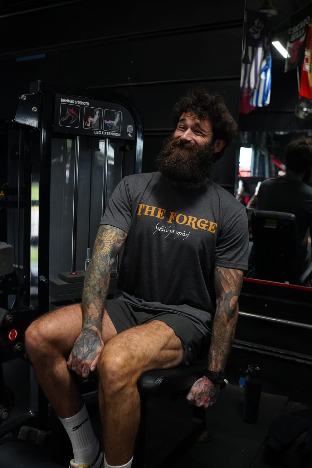 Joe Brooker smiling on the leg extension machine